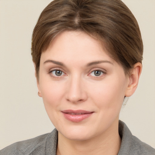 Joyful white young-adult female with short  brown hair and grey eyes