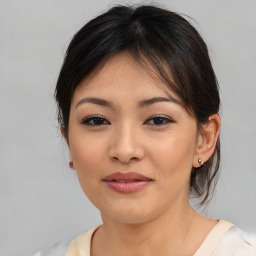 Joyful asian young-adult female with medium  brown hair and brown eyes