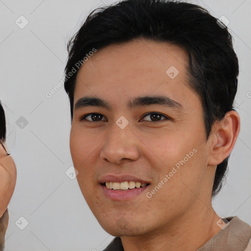 Joyful asian young-adult male with short  black hair and brown eyes