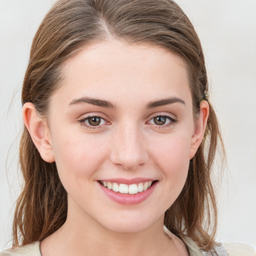 Joyful white young-adult female with medium  brown hair and blue eyes