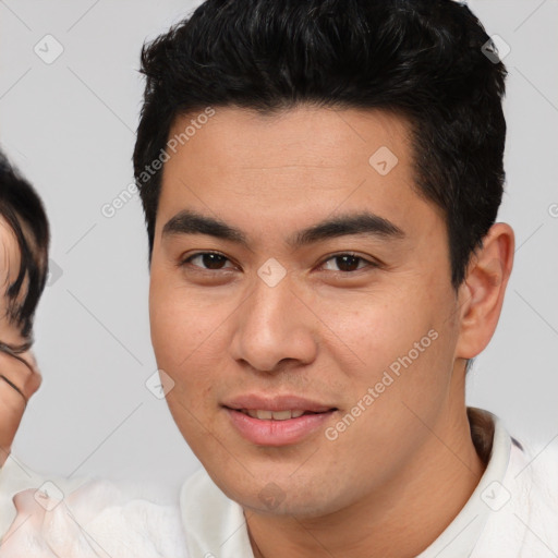 Joyful asian young-adult male with short  brown hair and brown eyes