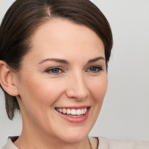 Joyful white young-adult female with medium  brown hair and brown eyes