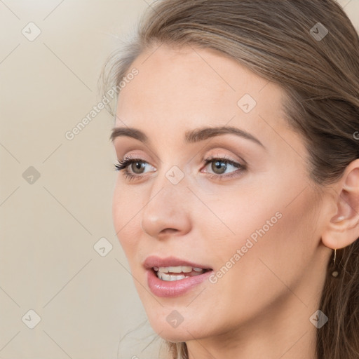 Joyful white young-adult female with long  brown hair and blue eyes