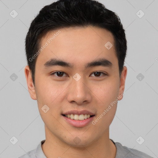 Joyful asian young-adult male with short  black hair and brown eyes