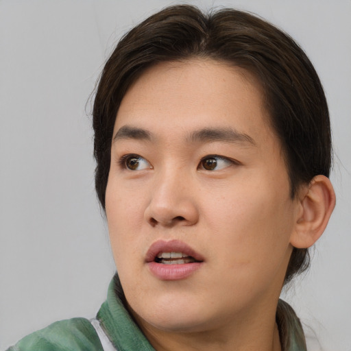Joyful asian young-adult male with medium  brown hair and brown eyes