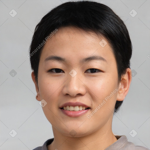 Joyful asian young-adult female with short  black hair and brown eyes