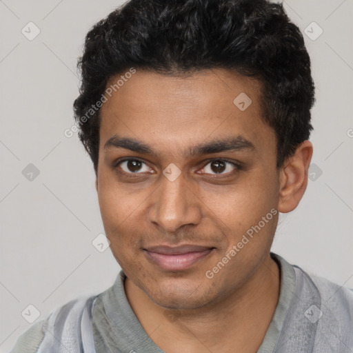 Joyful black young-adult male with short  brown hair and brown eyes