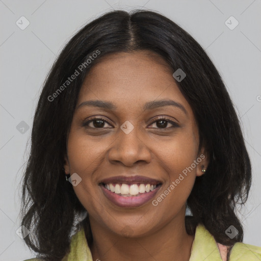 Joyful black young-adult female with long  brown hair and brown eyes