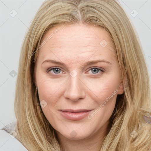 Joyful white young-adult female with long  brown hair and blue eyes