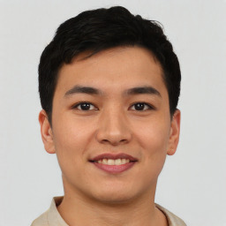 Joyful asian young-adult male with short  black hair and brown eyes