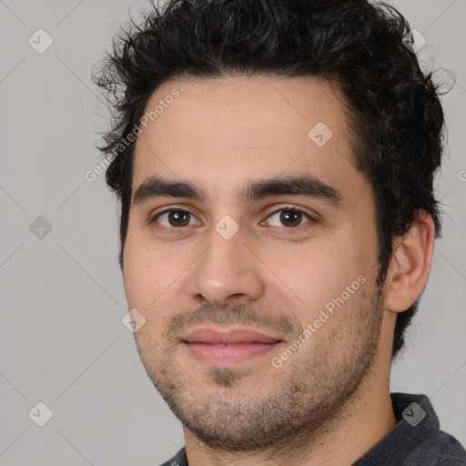 Joyful white young-adult male with short  black hair and brown eyes