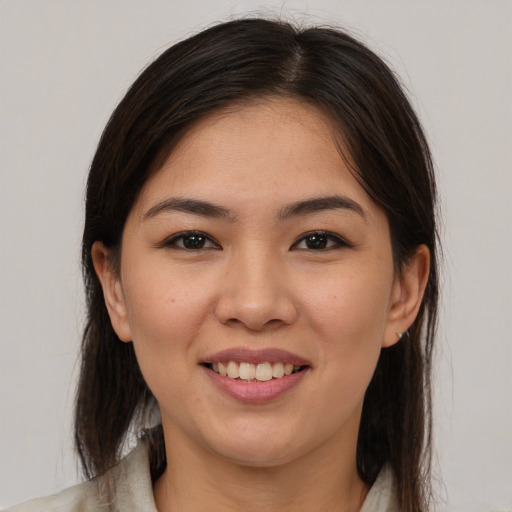 Joyful white young-adult female with medium  brown hair and brown eyes