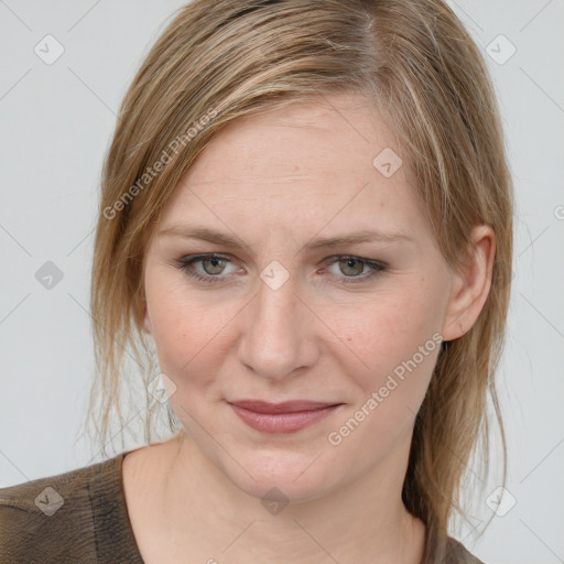 Joyful white young-adult female with medium  brown hair and blue eyes