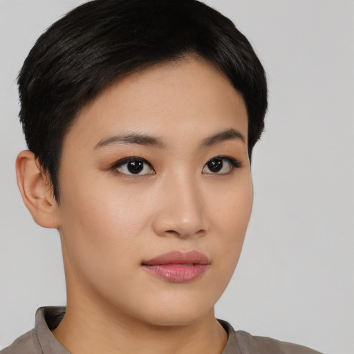 Joyful asian young-adult female with short  black hair and brown eyes