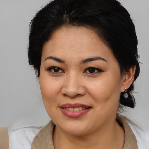 Joyful asian young-adult female with medium  brown hair and brown eyes