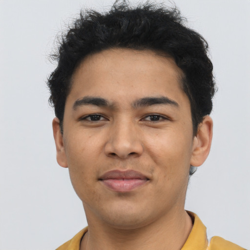 Joyful latino young-adult male with short  brown hair and brown eyes