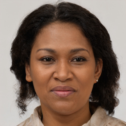 Joyful black adult female with medium  brown hair and brown eyes
