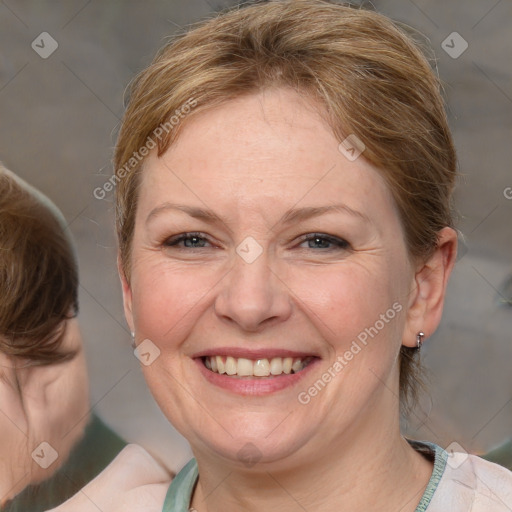 Joyful white adult female with medium  brown hair and blue eyes