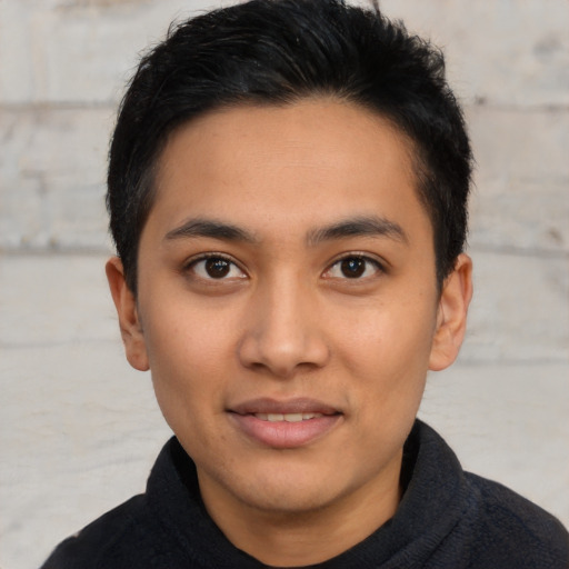 Joyful latino young-adult male with short  brown hair and brown eyes