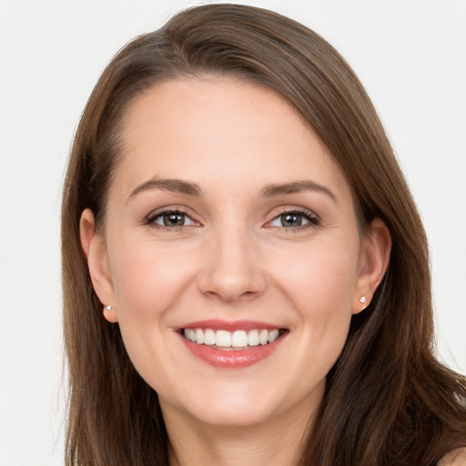 Joyful white young-adult female with long  brown hair and brown eyes