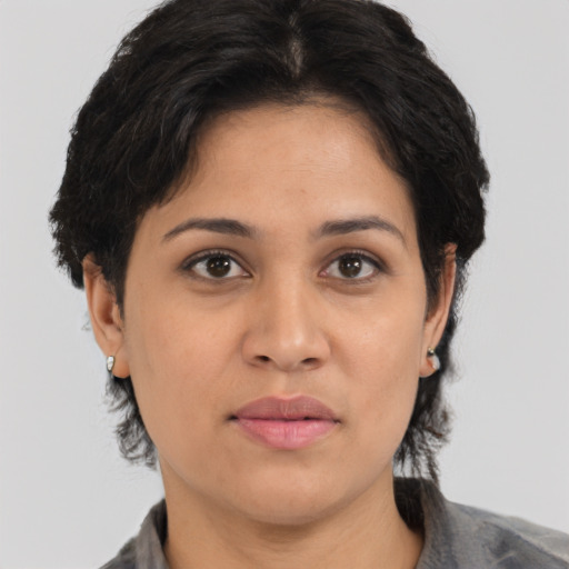 Joyful latino young-adult female with medium  black hair and brown eyes
