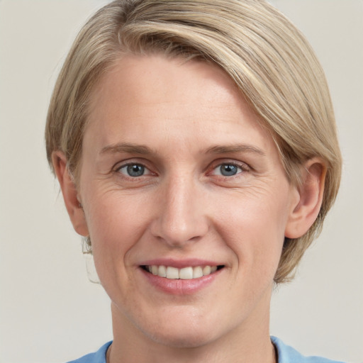 Joyful white adult female with medium  brown hair and blue eyes