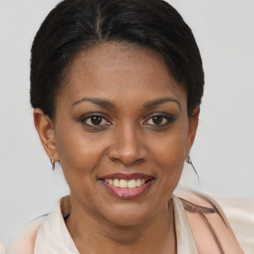 Joyful black young-adult female with short  brown hair and brown eyes