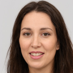 Joyful white adult female with long  brown hair and brown eyes