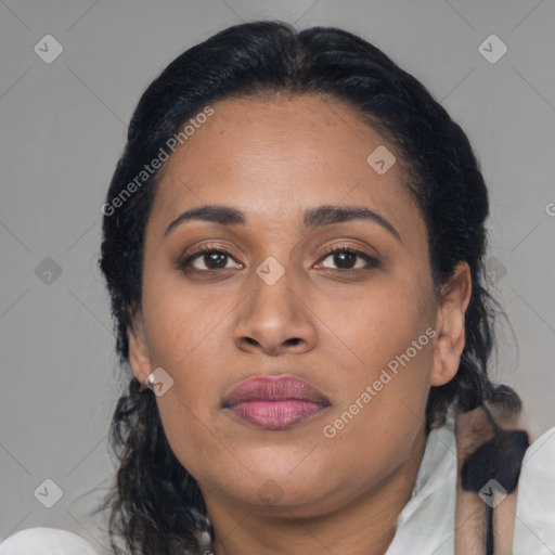 Joyful latino adult female with medium  brown hair and brown eyes