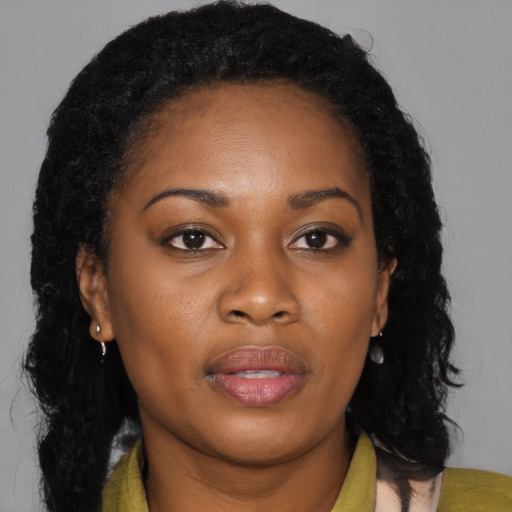 Joyful black young-adult female with long  brown hair and brown eyes