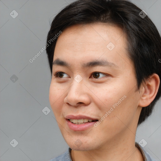 Joyful white young-adult male with short  black hair and brown eyes