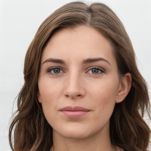 Joyful white young-adult female with long  brown hair and grey eyes