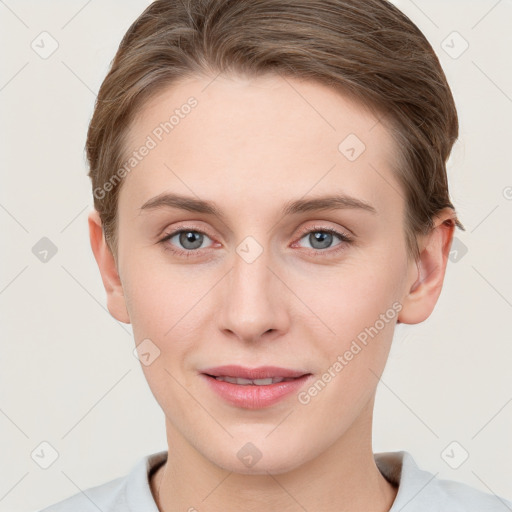 Joyful white young-adult female with short  brown hair and grey eyes