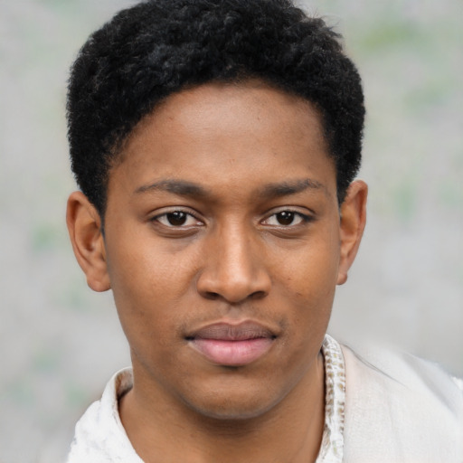 Joyful black young-adult male with short  brown hair and brown eyes