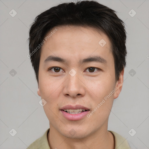 Joyful asian young-adult male with short  brown hair and brown eyes