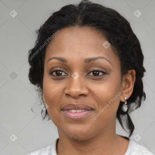 Joyful black adult female with medium  brown hair and brown eyes