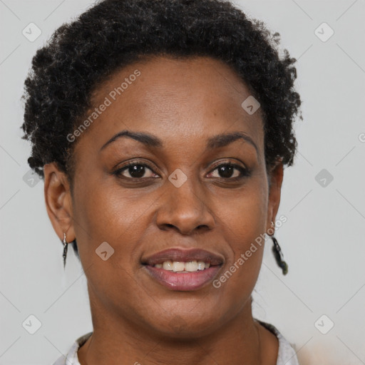 Joyful black adult female with short  brown hair and brown eyes