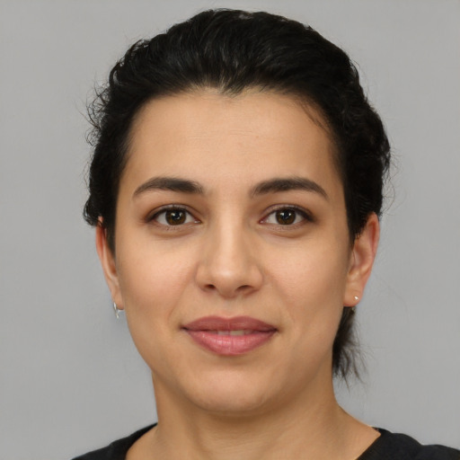 Joyful latino young-adult female with short  brown hair and brown eyes