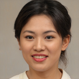 Joyful asian young-adult female with medium  brown hair and brown eyes