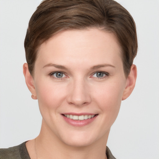 Joyful white young-adult female with short  brown hair and grey eyes