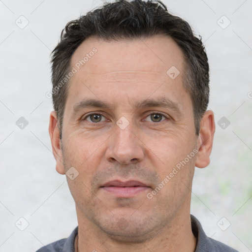 Joyful white adult male with short  brown hair and brown eyes