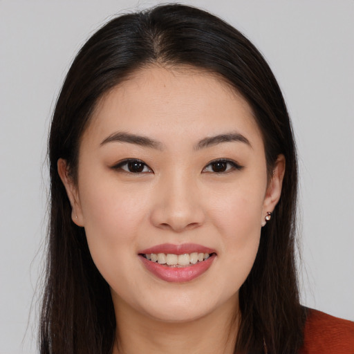 Joyful asian young-adult female with long  brown hair and brown eyes