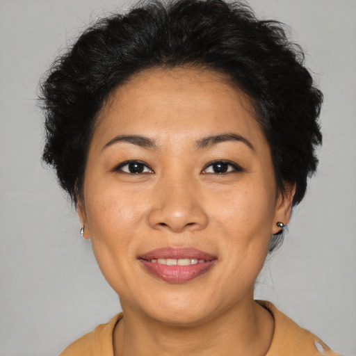 Joyful asian young-adult female with short  brown hair and brown eyes