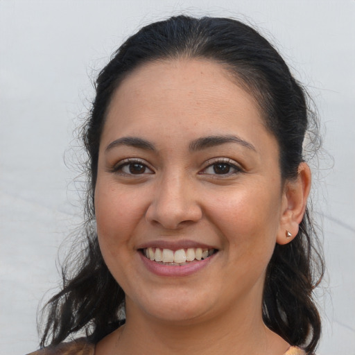 Joyful latino young-adult female with medium  brown hair and brown eyes