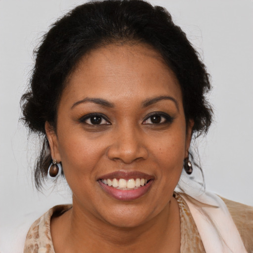 Joyful black adult female with medium  brown hair and brown eyes