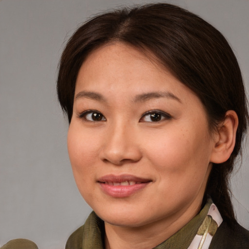 Joyful asian young-adult female with medium  brown hair and brown eyes