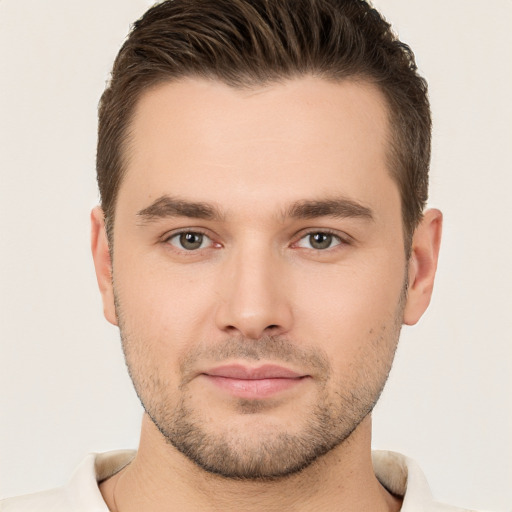 Joyful white young-adult male with short  brown hair and brown eyes