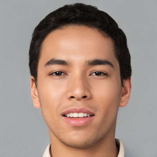 Joyful white young-adult male with short  black hair and brown eyes