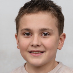 Joyful white child male with short  brown hair and brown eyes