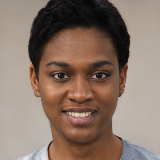 Joyful black young-adult female with short  black hair and brown eyes